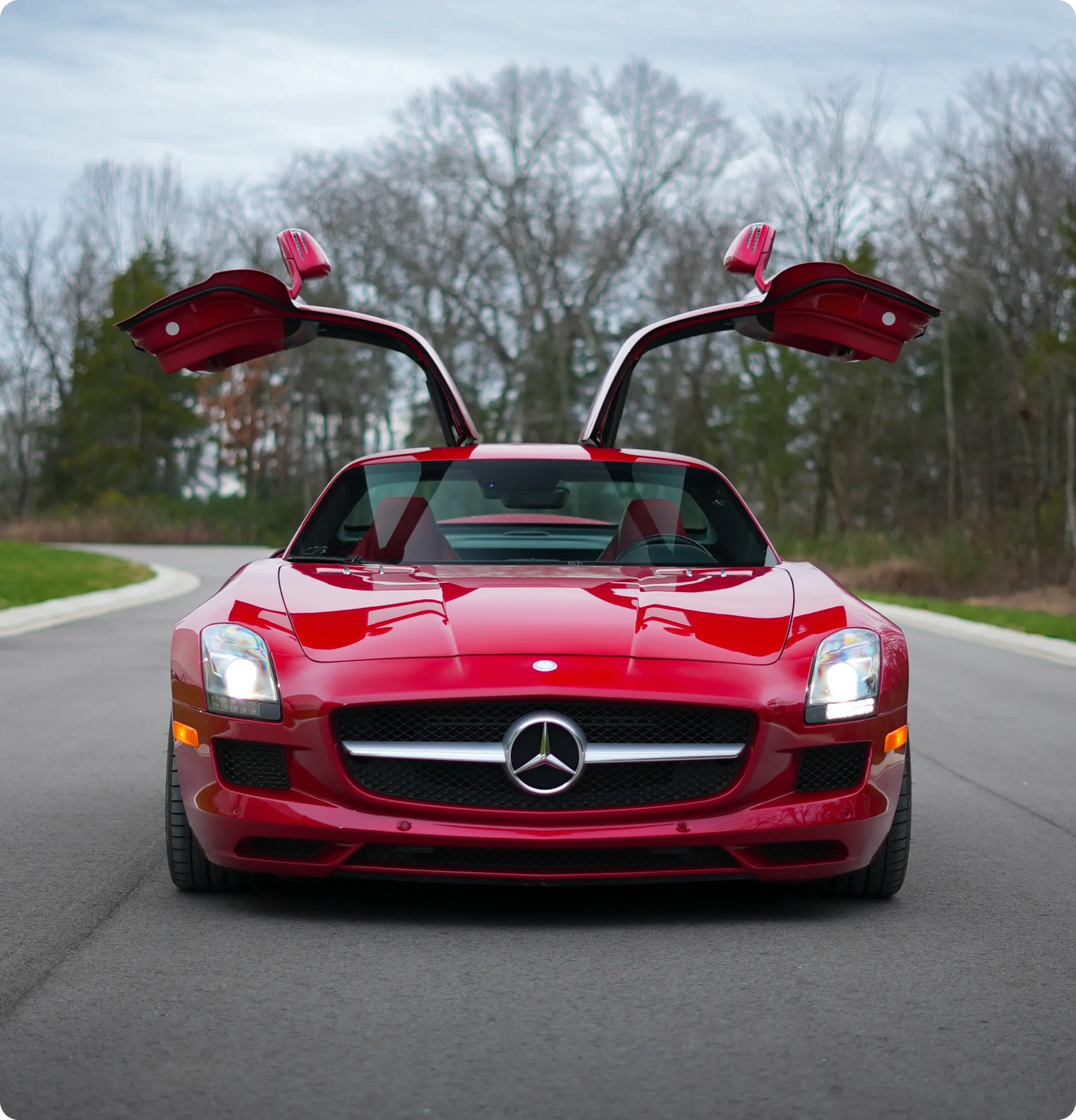 Red Mercedes-Benz SLS AMG with gullwing doors open - How it Works